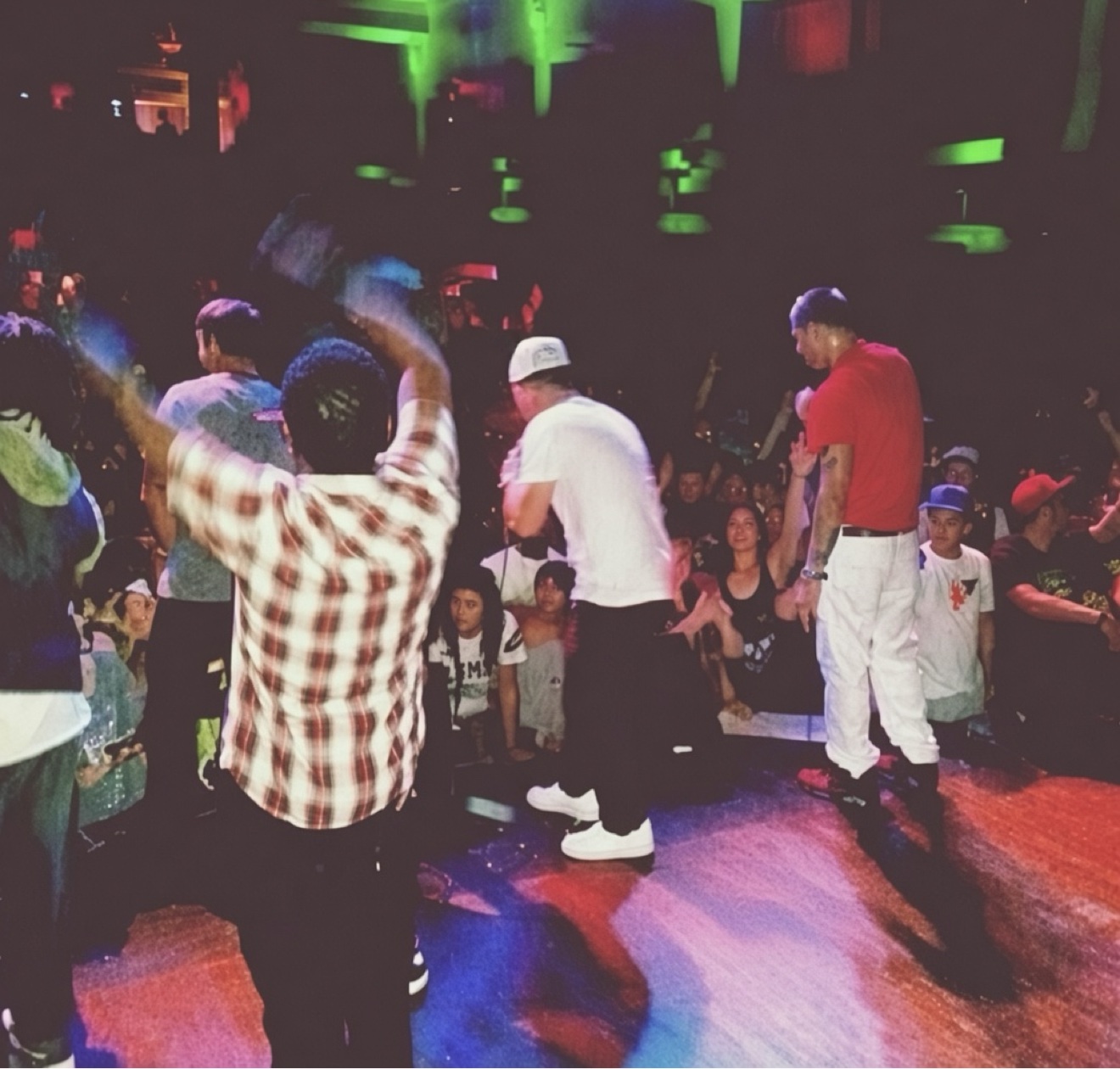 Vinny Chiodo performing his last sold-out show — white shirt and cap, center stage, rapping to the crowd with his hype men beside him